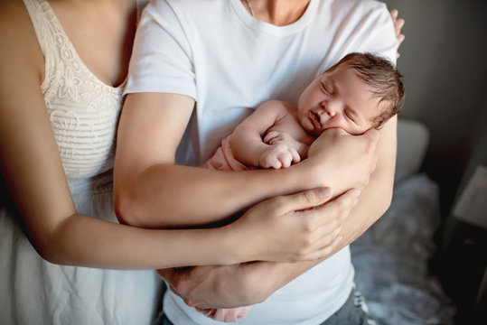 Newborn Baby With Mom And Dad At Home
