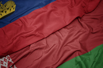 waving colorful flag of belarus and national flag of liechtenstein.