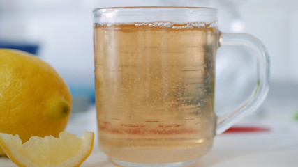 Fresh Sweet and Hot Cup with Tea and a Slice of Lemon at Breakfast Time in the Morning