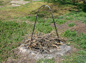 Metal stand for a cauldron to cook outdoors with firewood. A place for barbecue.