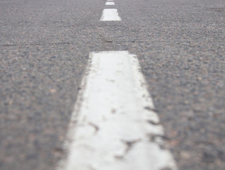 close-up dotted line on an empty street, a line extending into the distance.selective focus.