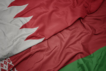 waving colorful flag of belarus and national flag of bahrain.