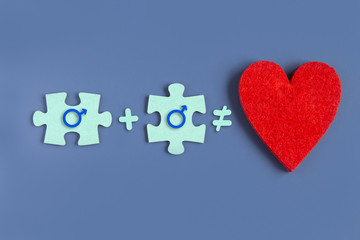 Two puzzle pieces and a heart idea of love on a blue background with signs of a man and a woman. Copyspace for love idea text