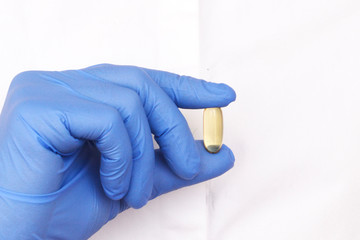 girl in latex gloves holds pills in her hands. Healthcare concept.