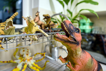 several plastic toys being washed in kitchen sink after outside kids party