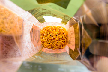 raw italian macaroni pasta inside clear packaging