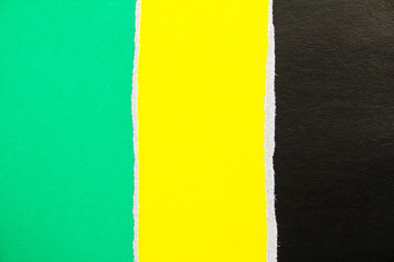 Green, yellow and black torn cardboard paper texture background. Copy space for text message.