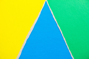 Blue, green and yellow torn and ripped pieces of cardboard paper texture background. Copy space for...