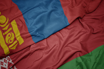 waving colorful flag of belarus and national flag of mongolia.