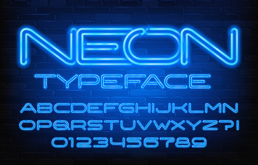 Neon alphabet font. Blue neon color letters and numbers. Brick wall background. Stock vector typescript for your design.