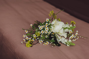 spring bride's bouquet on the bed. wedding day