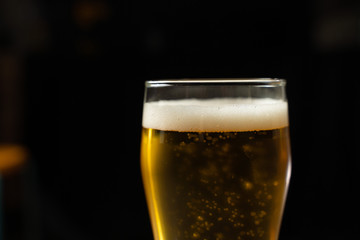 Close-up of goblets with pouring beer