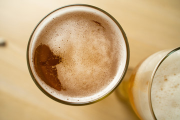 Close-up of goblets with pouring beer