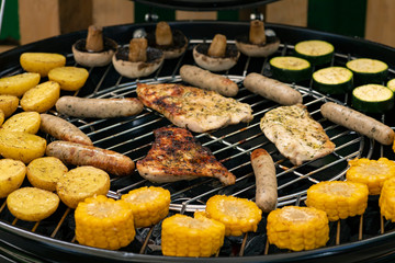 grill with potatoes, turkey meat, zucchini, mushrooms and sausages