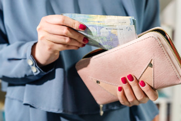Close up on euro EUR midsection money banknotes in hand unknown caucasian woman holding putting wallet after receiving payment loan help financial aid support due economic recession crisis front view