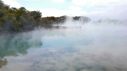 Fototapeta na wymiar Steams rising from a hot volcanic lake in Rotorua New Zealand