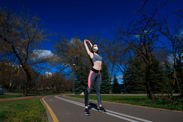 Fototapeta premium Woman runners morning exercise she wears a nose mask. Protection against dust and viruses