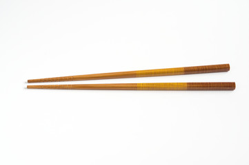 Wooden chopsticks isolated on white .