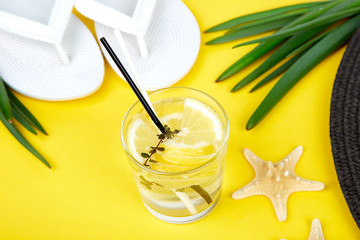 Colorful summer female fashion outfit. Black and white straw hat, flip flops