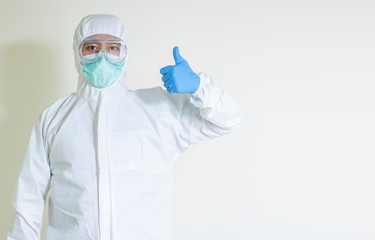 Fototapeta na wymiar man wear hazmat suit protect contagious disease covid-19 thumbs up isolated on white background