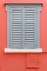 Fototapeta na wymiar Blue and red wooden window of a facade in Plaka neighborhood, Athens, Greece