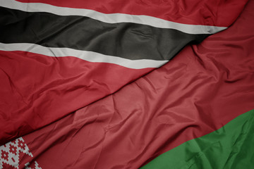 waving colorful flag of belarus and national flag of trinidad and tobago.
