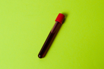 Test tube with blood isolate on a green background