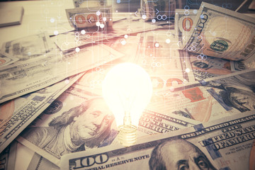 Double exposure of light bulb drawing over usa dollars bill background. Concept of idea.
