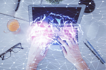 Double exposure of man's hands typing over computer keyboard and brain hologram drawing. Top view. Ai and data technology concept.