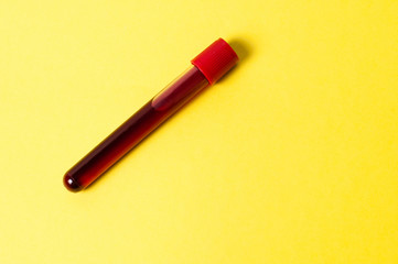 Test tube with blood isolate on a yellow background