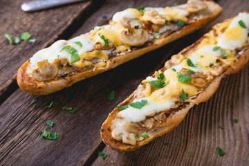 hot sandwich on a baguette with mushrooms and cheese