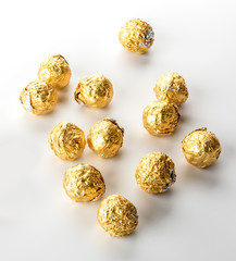 Golden wrapped candy isolated on white background
