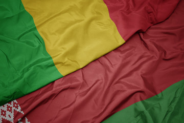 waving colorful flag of belarus and national flag of mali.