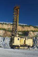 Quarry drilling rig inside the quarry, close-up. Heavy mining equipment.