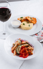 
dinner menu, feast and chicken cutlet with salad and red wine in combination with a tablecloth, tableware on the table