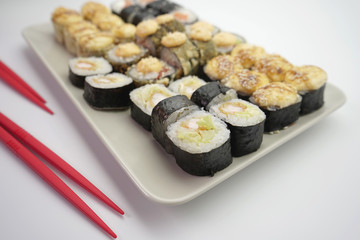sushi rolls with salmon and shrimp sprinkled with sesame seeds, close-up.