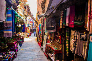 Market street shops, scarfs against Corona Virus, Bhaktapur, Nepal - obrazy, fototapety, plakaty