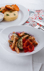 
dinner menu, feast and chicken cutlet with salad and red wine in combination with a tablecloth, tableware on the table