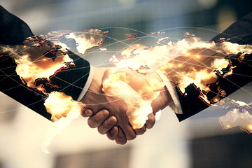 Double exposure of business theme hologram and handshake of two men. Success concept.