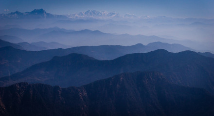 Aerial view of  layers of hills and mountains in western Nepal, on the flight to Rara Lake in Mugu from Nepalgunj. Layers of mountain range in the Himalayas.