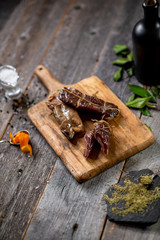 Beef jerky on wooden board with zest lemon spices salt