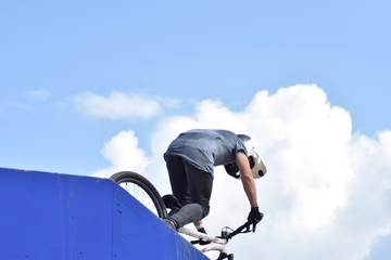 guy on bmx performing tricks in the air 