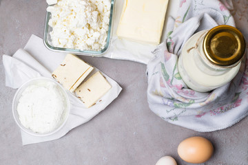 various dairy product on grey table with flower towel