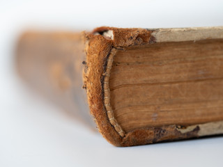 Old tattered book on white background.