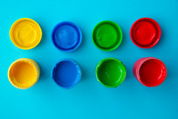 colorful paint buckets on a colored background
