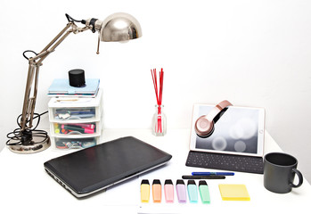 Laptop computer, tablet, headset in office set for working at home