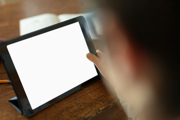 a handsome schoolboy aged 9 is making his classroom web lesson via tablet 