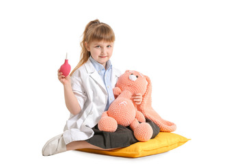 Cute little doctor with toy on white background