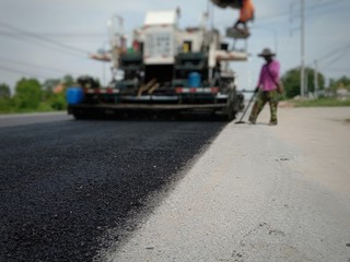 Road maintenance by the ASPHALT HOT MIX IN - PLACE RECYCLING (blurred image).