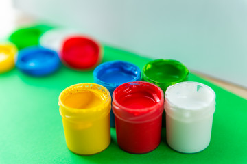 colorful paint buckets on a colored background